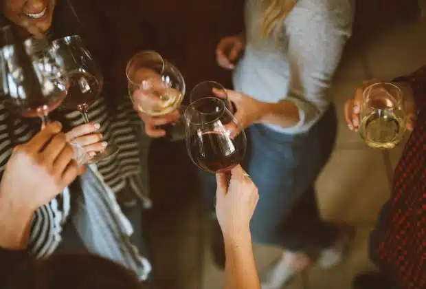 group of people tossing wine glass